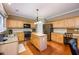 Traditional kitchen with wood cabinets, stainless steel appliances, granite countertops, and center island at 199 Eastham Ct, Suwanee, GA 30024
