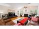 Cozy living room with fireplace, hardwood floors and comfortable furniture at 199 Eastham Ct, Suwanee, GA 30024
