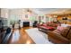 Spacious living room with a fireplace, ample seating, and seamless flow to the kitchen at 199 Eastham Ct, Suwanee, GA 30024