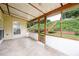 Relaxing sunroom with tiled floor and screened windows overlooking a landscaped backyard and stairway at 199 Eastham Ct, Suwanee, GA 30024