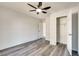 Bedroom features wood-look floors, a ceiling fan and access to a closet at 2216 Marbut Farms Trce, Lithonia, GA 30058