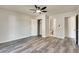 A bright bedroom with gray walls, wood-look floors, ceiling fan, and closet at 2216 Marbut Farms Trce, Lithonia, GA 30058