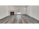 Inviting living room showcasing sleek wood floors, a cozy fireplace, and ample natural light from the window at 2216 Marbut Farms Trce, Lithonia, GA 30058