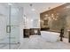 Luxurious bathroom featuring a soaking tub, glass shower, elegant vanity, and modern light fixture at 2497 Wawona Dr, Brookhaven, GA 30319