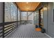 Spacious front porch with wooden ceiling, contemporary lighting, and black railings, creating a cozy entrance at 2497 Wawona Dr, Brookhaven, GA 30319