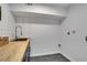 Laundry room with sink, wood counter, and modern fixtures at 2497 Wawona Dr, Brookhaven, GA 30319