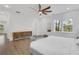 Bright main bedroom featuring hardwood floors, a ceiling fan, large windows and stylish furnishings at 2497 Wawona Dr, Brookhaven, GA 30319