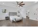 Bright main bedroom featuring hardwood floors, a ceiling fan, large windows and elegant furnishings at 2497 Wawona Dr, Brookhaven, GA 30319