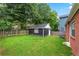 Large backyard with a black garage and fencing at 50 Ormond Sw St, Atlanta, GA 30315