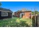 Well-maintained backyard with a brick house, garage, and a secure wooden fence, offering a private outdoor space at 50 Ormond Sw St, Atlanta, GA 30315