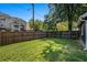 Large, grassy backyard enclosed by a wood fence, perfect for outdoor activities and privacy at 50 Ormond Sw St, Atlanta, GA 30315
