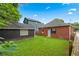 Backyard featuring green grass, a fenced perimeter, and access to additional buildings at 50 Ormond Sw St, Atlanta, GA 30315