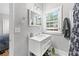 Bright bathroom with white vanity, classic mirror, and natural light from a large window at 50 Ormond Sw St, Atlanta, GA 30315
