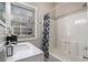 Bathroom featuring a white vanity with a marble top and a tub with a patterned shower curtain at 50 Ormond Sw St, Atlanta, GA 30315