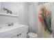Bright bathroom featuring a white vanity and modern fixtures, complemented by a colorful shower curtain at 50 Ormond Sw St, Atlanta, GA 30315
