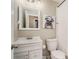 Bathroom with white tile, a white vanity, and artwork of a dog wearing headphones and sunglasses at 50 Ormond Sw St, Atlanta, GA 30315