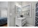 Bright bathroom featuring a white vanity with a marble top and a view into an adjacent bedroom at 50 Ormond Sw St, Atlanta, GA 30315