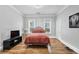Bedroom features warm lighting, hardwood floors, and neutral paint at 50 Ormond Sw St, Atlanta, GA 30315