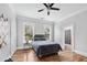 Bedroom featuring hardwood floors, natural light from two windows, and ensuite bathroom at 50 Ormond Sw St, Atlanta, GA 30315