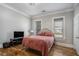 Cozy bedroom with hardwood floors, two windows, a TV, and neutral-toned walls at 50 Ormond Sw St, Atlanta, GA 30315