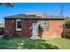 Brick house featuring a well-maintained lawn, a blue door, and small windows at 50 Ormond Sw St, Atlanta, GA 30315