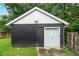Detached garage or shed with a double door and grassy surroundings at 50 Ormond Sw St, Atlanta, GA 30315