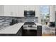 Updated kitchen with stainless steel stove, microwave, sleek countertops, and modern backsplash at 50 Ormond Sw St, Atlanta, GA 30315