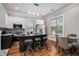 Contemporary kitchen with black and white cabinetry, stainless steel appliances and eat in bar at 50 Ormond Sw St, Atlanta, GA 30315