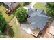 Aerial view showcases the backyard layout, including a patio and firepit, bordered by mature trees offering ample privacy at 6061 Meridian Nw Dr, Acworth, GA 30101