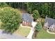 An aerial view shows this beautiful home, with a lush lawn, mature trees, and a curved driveway at 6061 Meridian Nw Dr, Acworth, GA 30101