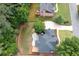 Aerial view displays the home's layout with its spacious backyard, a patio with an outdoor seating area, and surrounding mature trees at 6061 Meridian Nw Dr, Acworth, GA 30101