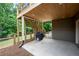 Covered back patio area with stairs leading to deck, grill, and lawn at 6061 Meridian Nw Dr, Acworth, GA 30101