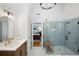 Bathroom with white marble floors, glass shower, and wood vanity leading into primary bedroom at 6061 Meridian Nw Dr, Acworth, GA 30101