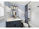 Bathroom featuring a gray vanity, framed mirror, and tiled tub with a black and white shower curtain at 6061 Meridian Nw Dr, Acworth, GA 30101
