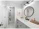 Clean bathroom featuring a stylish vanity with a round mirror and tiled shower at 6061 Meridian Nw Dr, Acworth, GA 30101