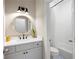 Bathroom with a round mirror, white cabinets, and a tub with a shower at 6061 Meridian Nw Dr, Acworth, GA 30101