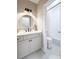 Bathroom with a round mirror, white cabinets, and a tub with a shower and pebble floors at 6061 Meridian Nw Dr, Acworth, GA 30101