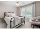Bedroom with a black iron bed frame, neutral colored walls and floors, with a papasan chair in the corner at 6061 Meridian Nw Dr, Acworth, GA 30101