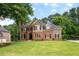 Elegant two-story home with manicured lawn and mature trees in a serene setting at 6061 Meridian Nw Dr, Acworth, GA 30101