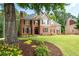 Charming two-story home with a lush green lawn and colorful flowerbeds at 6061 Meridian Nw Dr, Acworth, GA 30101