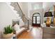 Stately foyer with hardwood floors, elegant staircase, and arched doorway at 6061 Meridian Nw Dr, Acworth, GA 30101