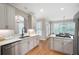 Bright kitchen with hardwood floors, stainless steel appliances, and white countertops at 6061 Meridian Nw Dr, Acworth, GA 30101