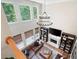 Cozy living room with a leather sofa, fireplace, chandelier, and bookshelves under large windows at 6061 Meridian Nw Dr, Acworth, GA 30101