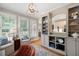 Open living room with hardwood floors and shelving unit and an open concept view to the kitchen at 6061 Meridian Nw Dr, Acworth, GA 30101