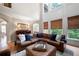 Spacious living room features a leather sectional couch and large windows at 6061 Meridian Nw Dr, Acworth, GA 30101