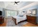 Primary bedroom featuring a tray ceiling, large windows and ensuite bathroom at 6061 Meridian Nw Dr, Acworth, GA 30101