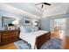 This primary bedroom has a tray ceiling, large windows, ensuite bathroom and hardwood floors at 6061 Meridian Nw Dr, Acworth, GA 30101