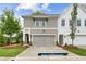 Charming townhome featuring a two-car garage, manicured lawn and traditional architecture at 101 Priestwood Ln, Acworth, GA 30102