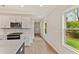 Modern kitchen featuring sleek white cabinets, stainless steel appliances, and light wood flooring at 101 Priestwood Ln, Acworth, GA 30102