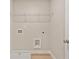 Functional laundry room with shelving, a utility sink and durable flooring at 101 Priestwood Ln, Acworth, GA 30102